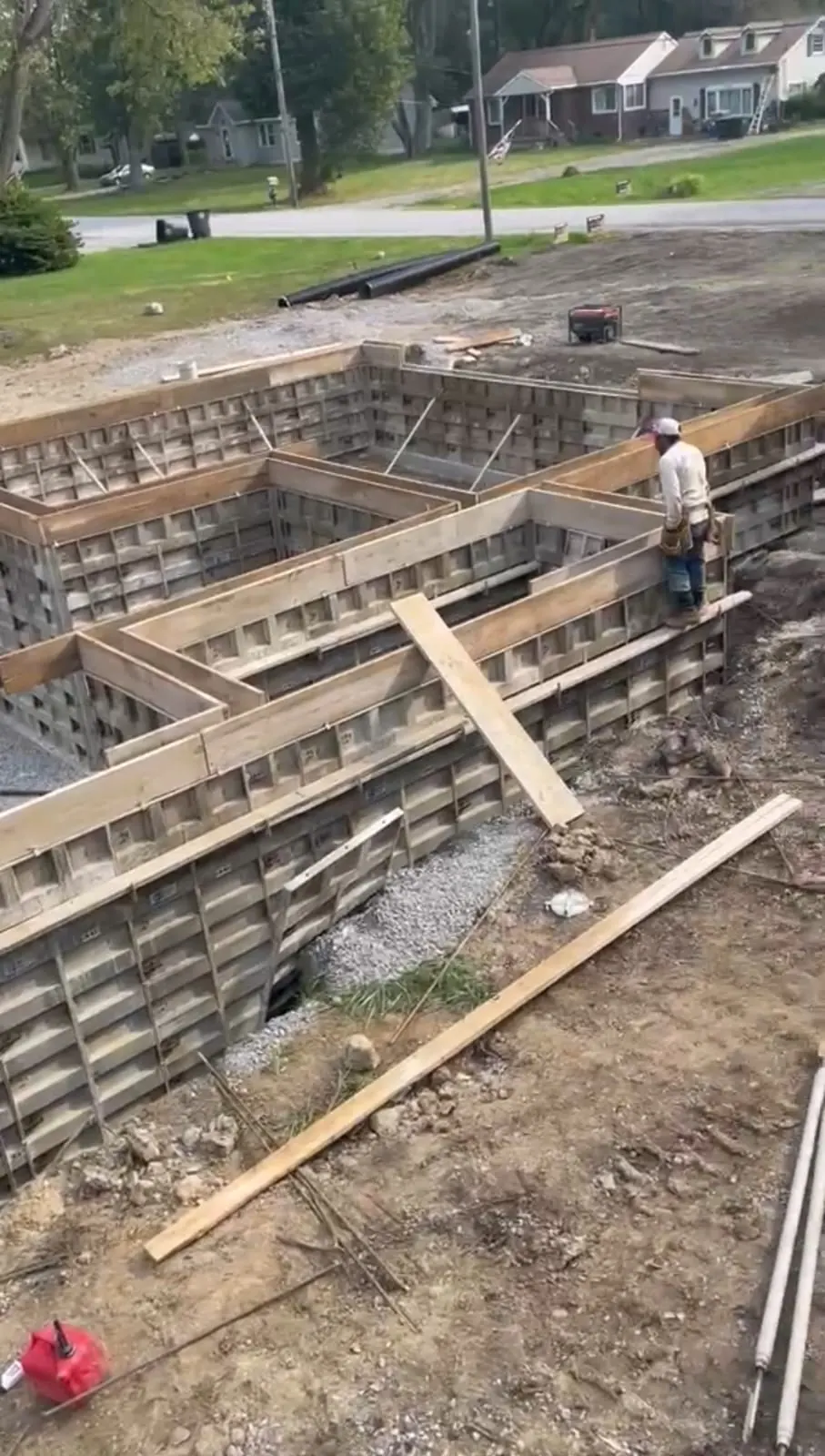 Overhead view of wood footing forms laid out for a multi-room foundation